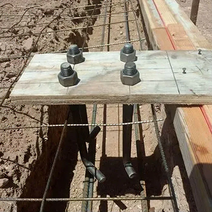 Cast-in anchor bolts set in a footing with a wooden template